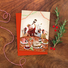 Greeting card with festive illustration of people celebrating with champagne at a table on a wooden surface with decorative elements.