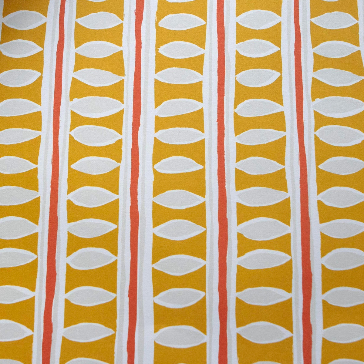 Patterned paper with vertical stripes and leaf shapes on a yellow background