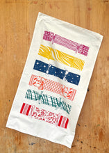 A cotton tea towel with 6 different Christmas crackers in traditional and fun designs.