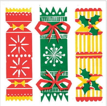 Three festive Christmas-themed crackers on a white background: a red cracker with yellow and white patterns, a green cracker with red ribbon and white snowflake, and a yellow striped cracker with green holly and red trim.