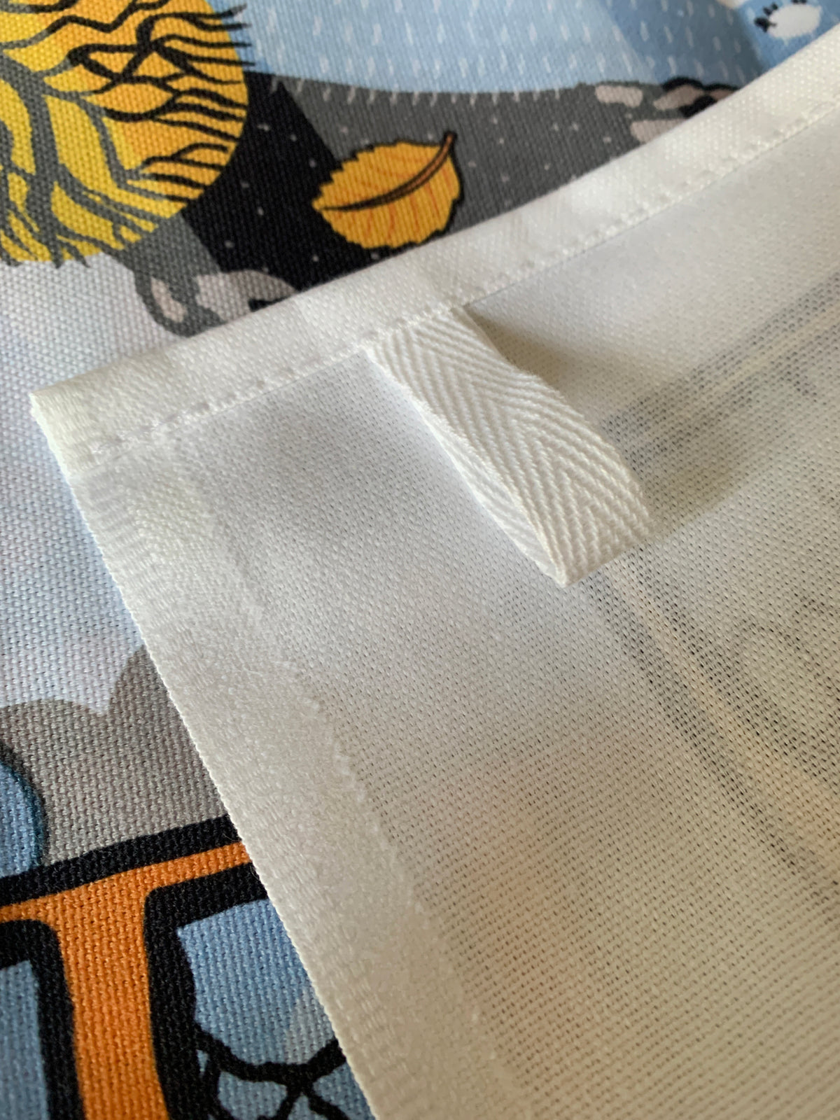 Close-up of reverse of Huggable Rock Dartmoor tea towel with hanging loop.