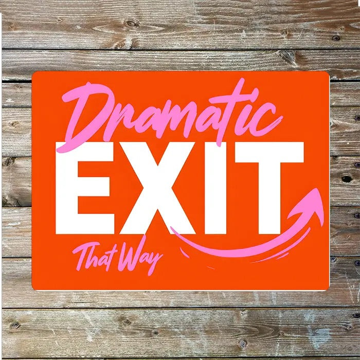 Red sign with 'Dramatic EXIT That Way' text on a wooden background