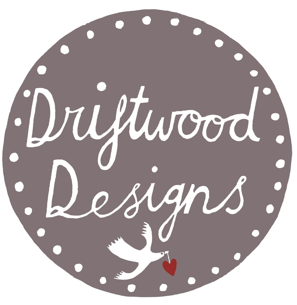 Driftwood Designs logo with a dove and heart on a grey background.