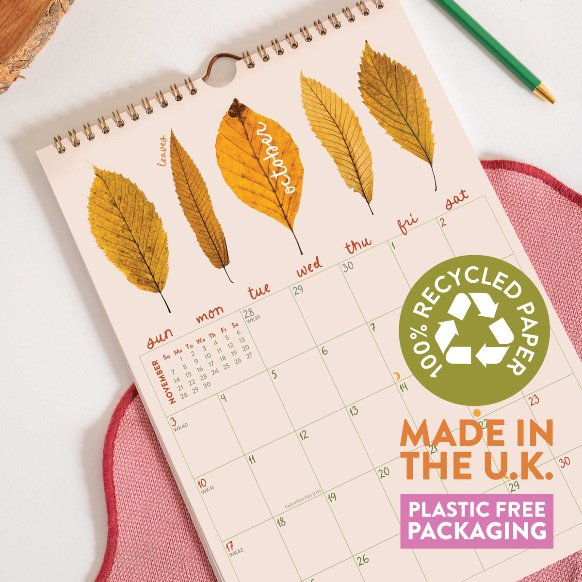 Calendar with leaf design and recycled paper label on a white surface
