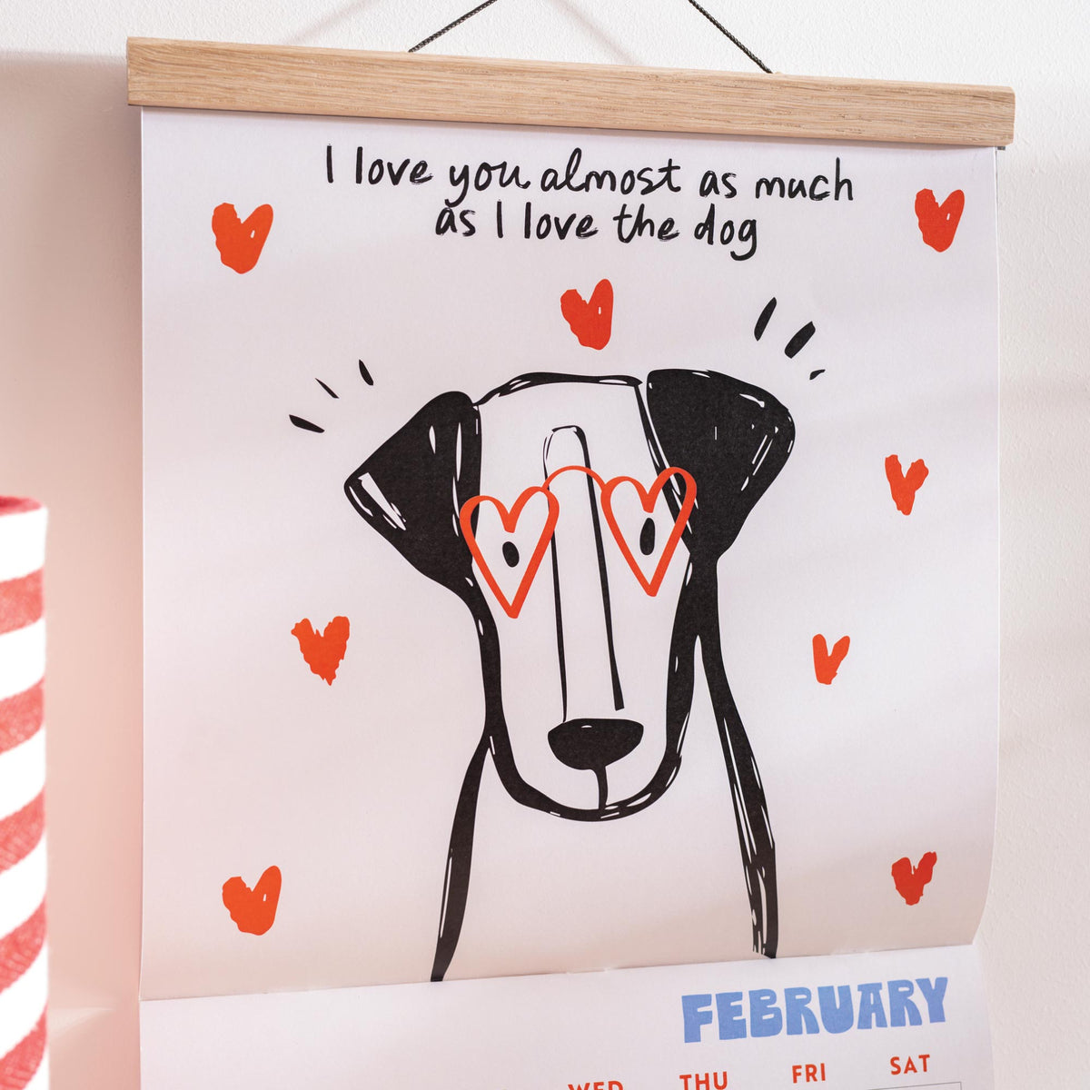 Calendar with a dog illustration and text 'I love you almost as much as I love the dog' on a light background.