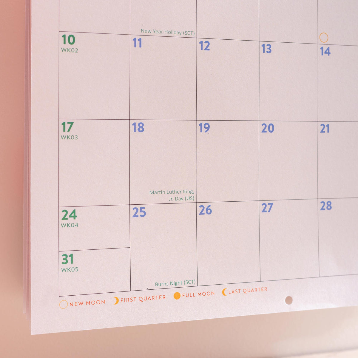 Calendar with dates and holidays marked on a light background