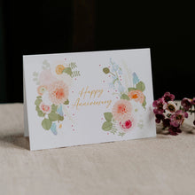 Greeting card with floral design and 'Happy Anniversary' text on a dark background