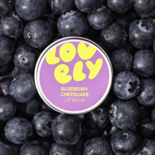 Lovelily blueberry cheesecake lip balm tin surrounded by blueberries