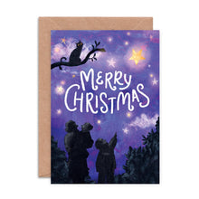 Christmas card with silhouette of people and cat under a starry sky, with a purple background.