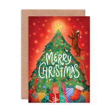 Christmas card with a dog on a ladder, tree, presents, and 'Merry Christmas' text.