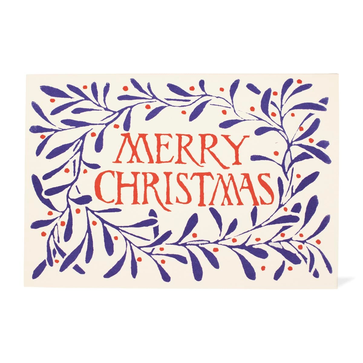 A Christmas greeting card with an off-white background, featuring a navy blue leafy wreath with small red berries and the words 'MERRY CHRISTMAS' in red lettering in the center.
