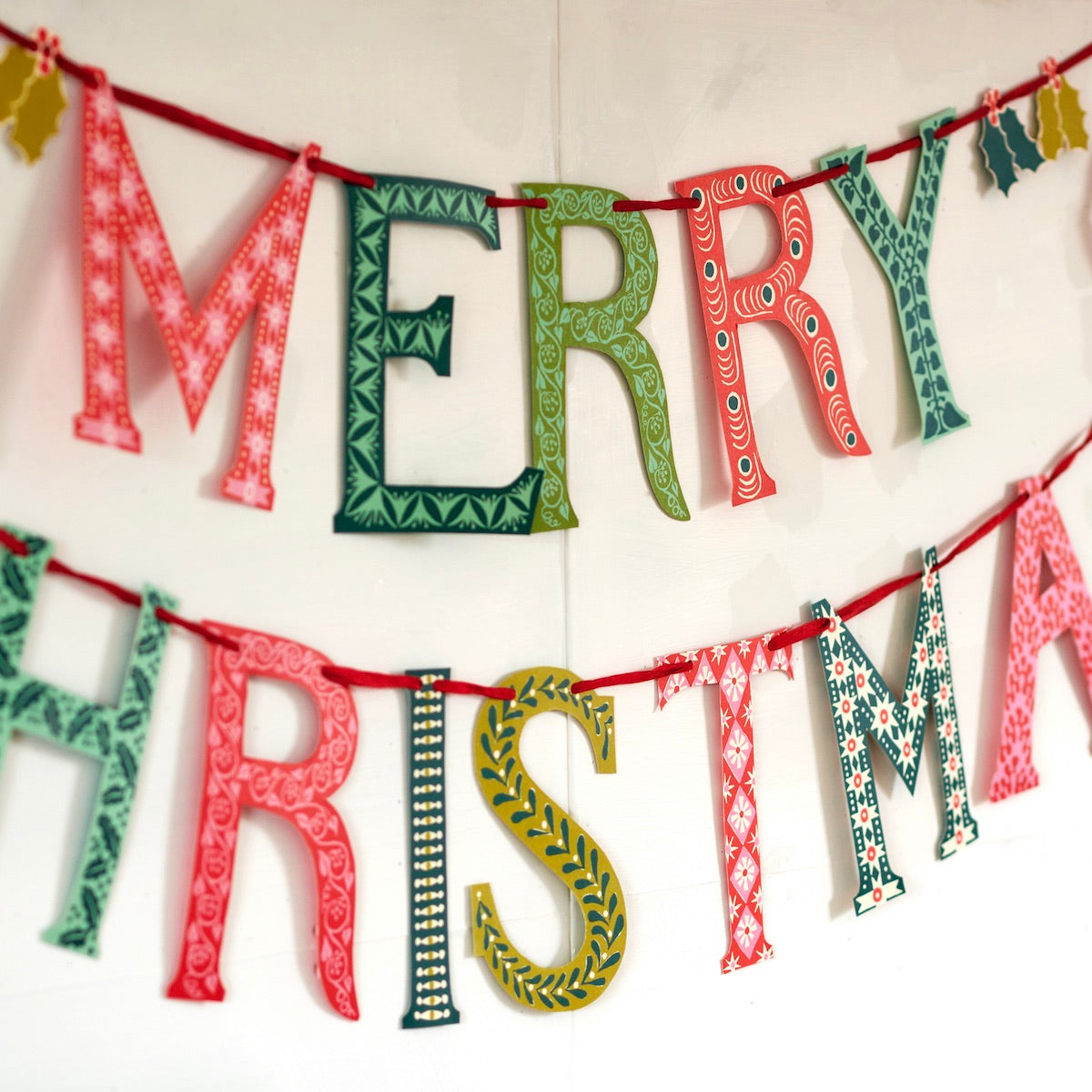 Decorative 'Merry Christmas' banner with patterned letters on a white background