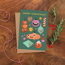 Christmas card with cartoon Christmas decorations on a wooden surface with decorative elements.