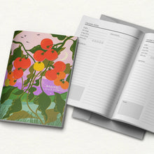 Recipe logbook with tomato-themed cover and open pages on a white background