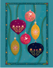 A Christmas card decorative illustration featuring six hanging Christmas ornaments in purple, pink, yellow, and navy on a teal background with pine branches and gold stars.