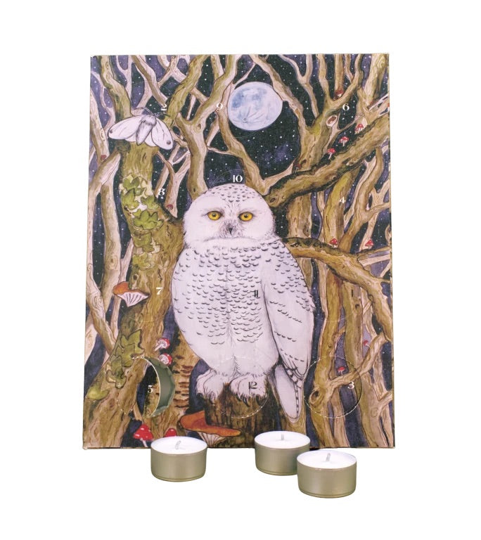 Advent calendar featuring a painted snowy owl perched among bare trees under a full moon, shown against a white background with three small tealight candles in front.